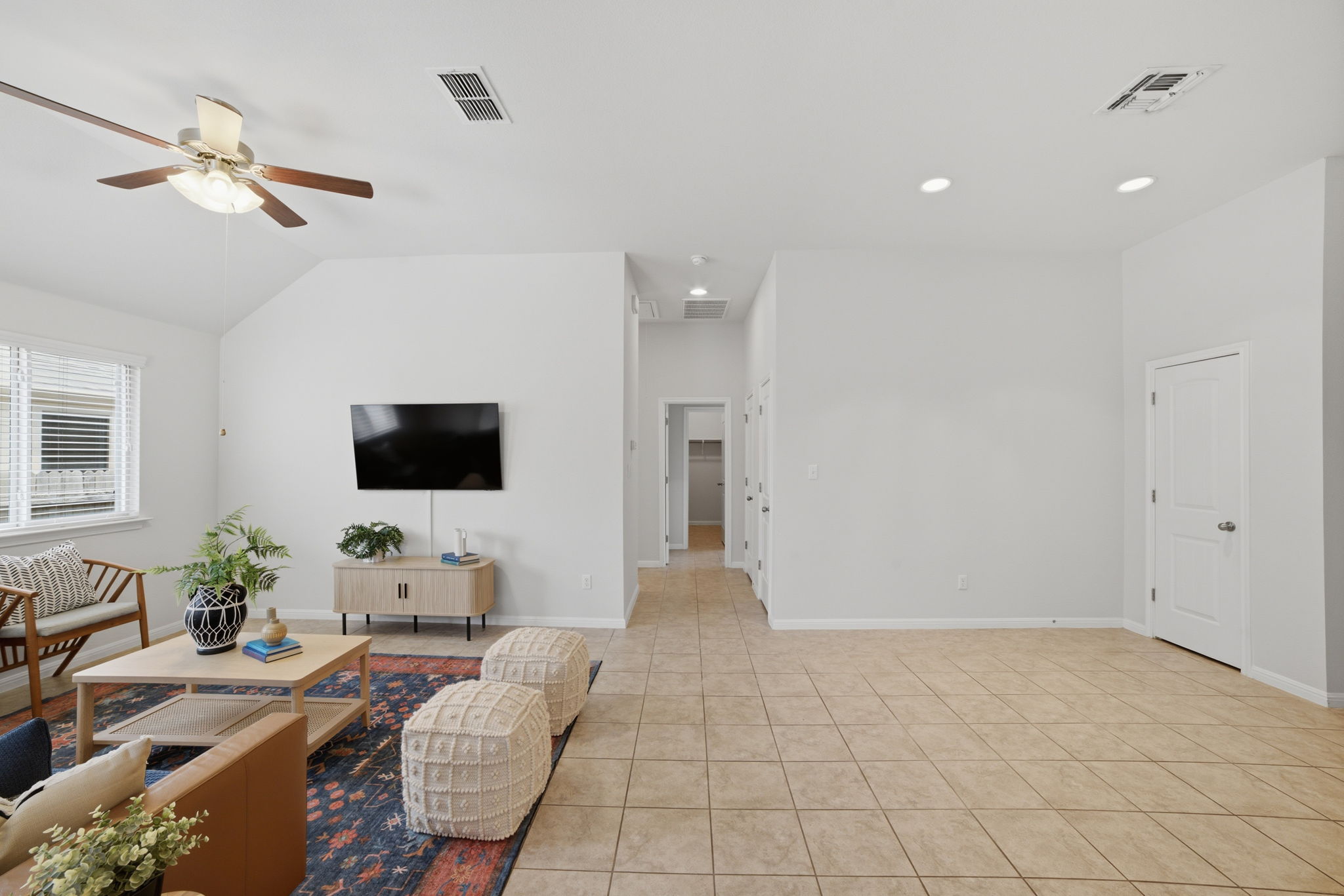 514 Nautical Loop Kyle, TX 78640 - Photo 7 of 24 Cathedral ceilings enhance this bright living space, featuring recessed lighting and durable tile flooring throughout.