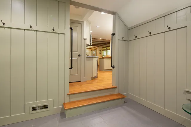 a view of a storage & utility room with refrigerator and cabinet