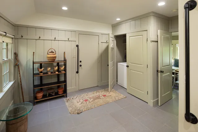 a living room with furniture and a potted plant on the table