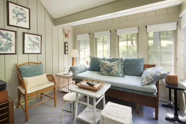 a bedroom with a large bed and a flat tv screen on dresser