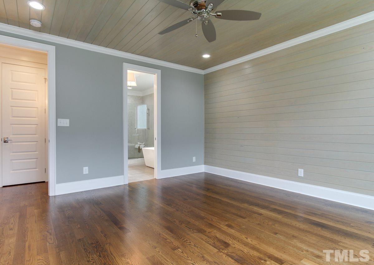 8809 Breeland Way Raleigh, NC 27613 - Photo 14 of 25 wooden floor in an empty room with a window