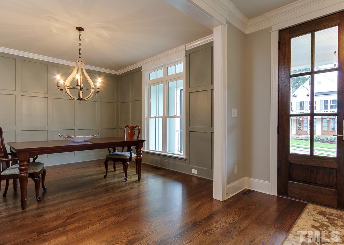 8809 Breeland Way Raleigh, NC 27613 - Photo 3 of 25 a view of a dining room with furniture window and wooden floor