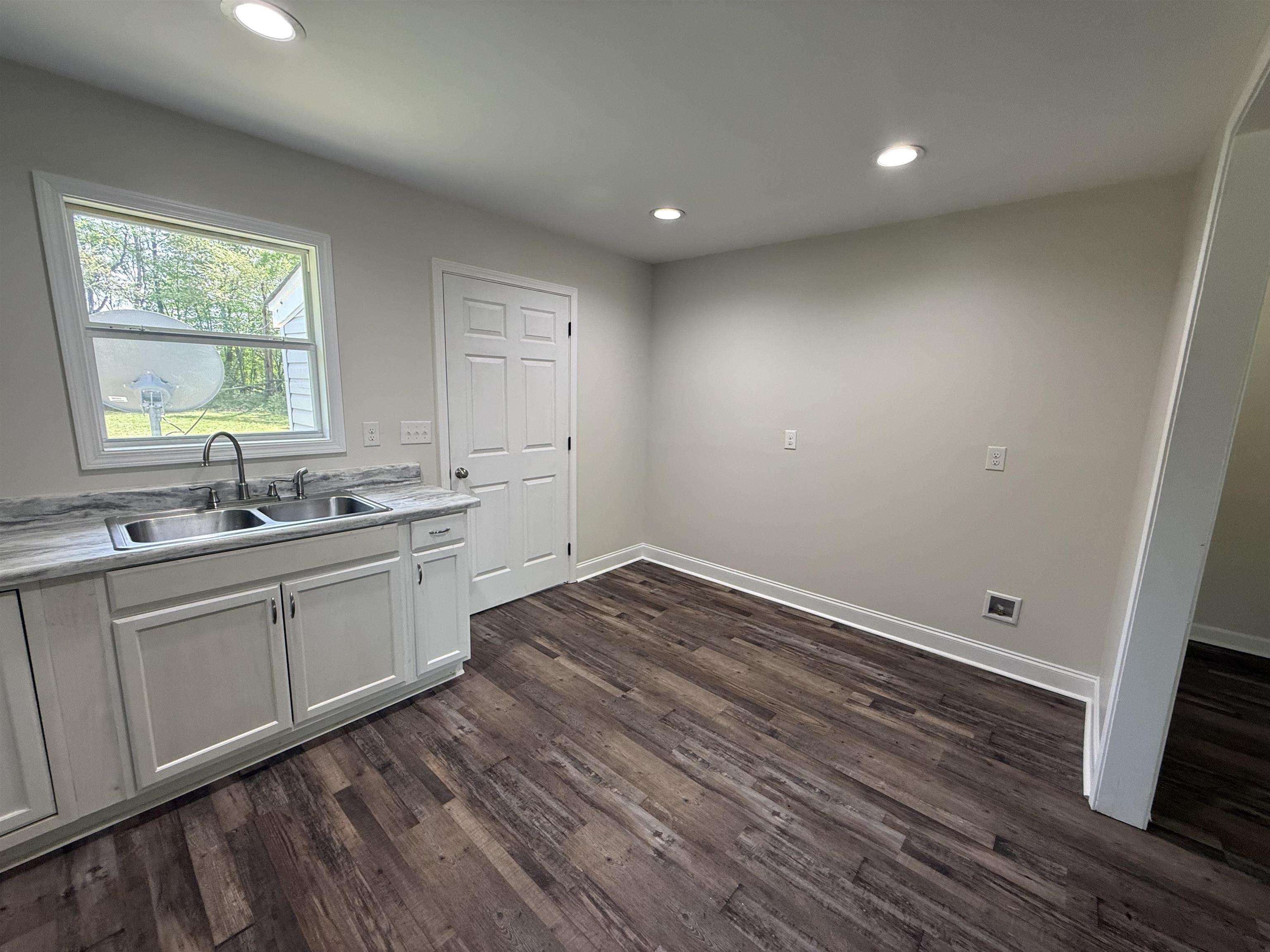 112 Tapp Drive Somerville, TN 38068 - Photo 5 of 16 a kitchen with sink cabinets and wooden floor