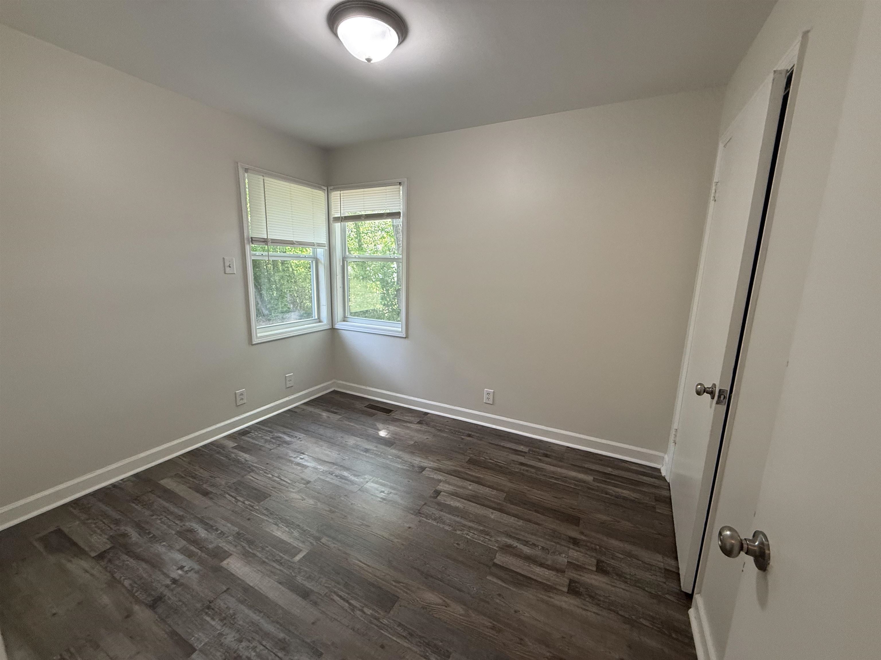 112 Tapp Drive Somerville, TN 38068 - Photo 7 of 16 an empty room with wooden floor and windows
