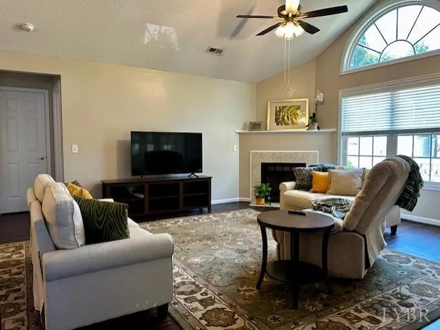 a living room with furniture a flat screen tv and a fireplace