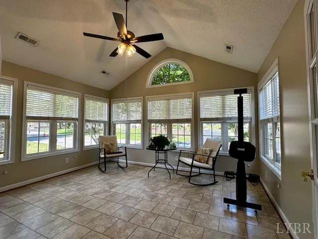 a living room with furniture and floor to ceiling windows