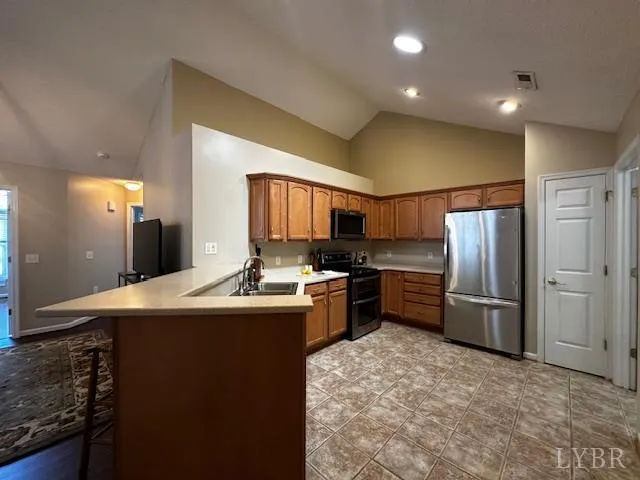 a kitchen with refrigerator and cabinets