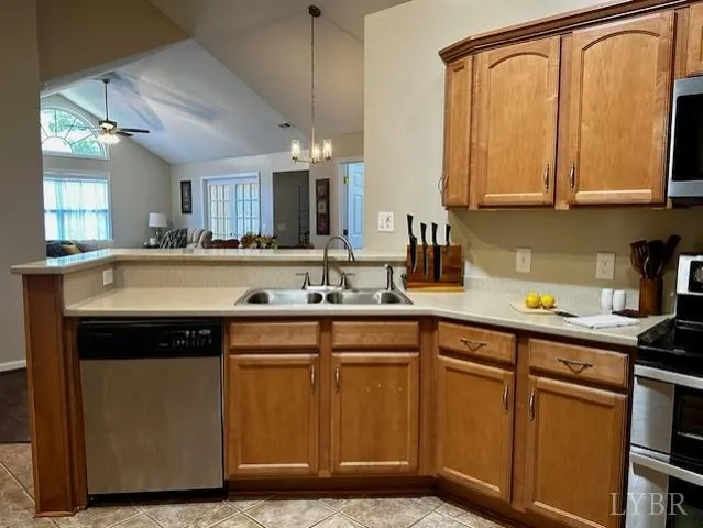 a kitchen with stainless steel appliances granite countertop a sink and cabinets