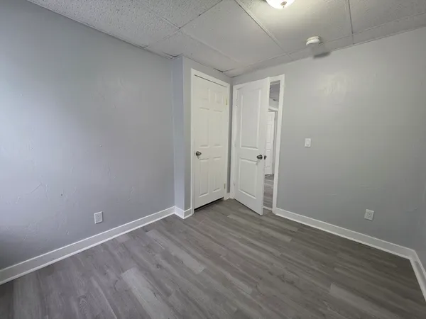 a view of an empty room with wooden floor