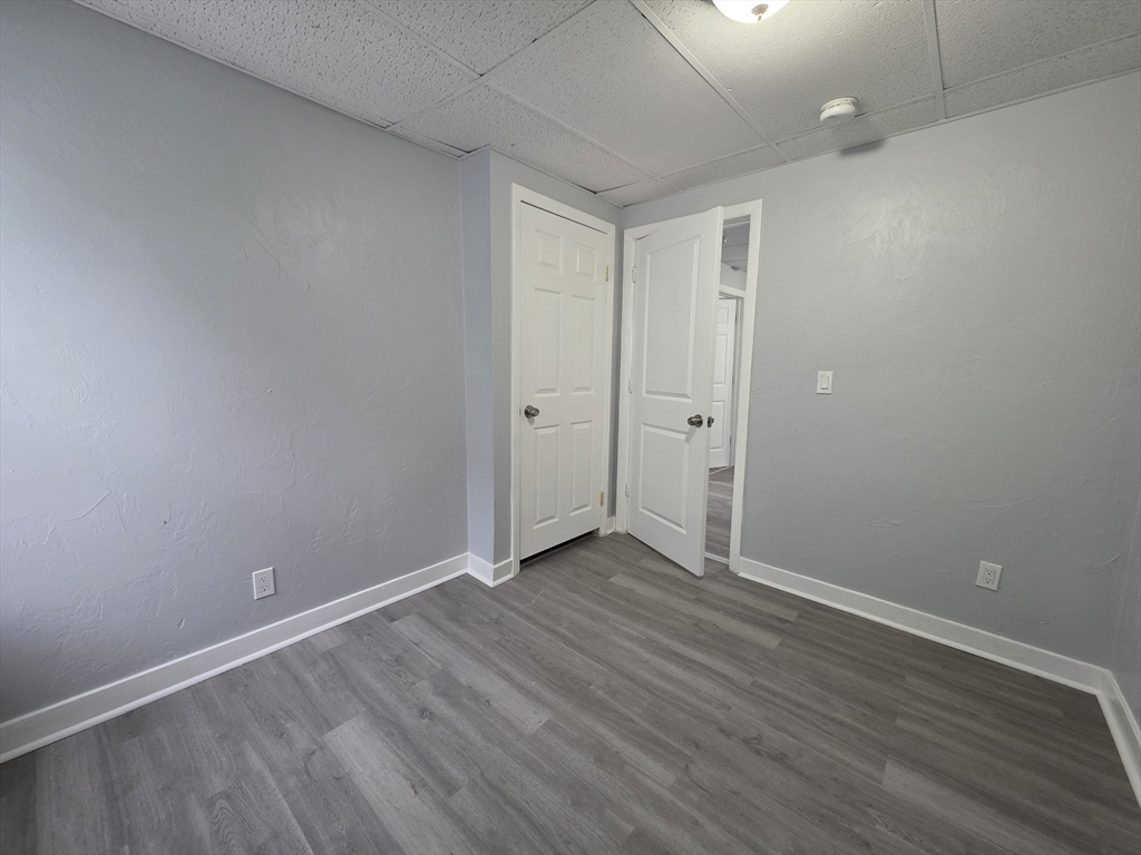 39 Harlem Street, Unit 3 Worcester, MA 01610 - Photo 16 of 18 a view of an empty room with wooden floor