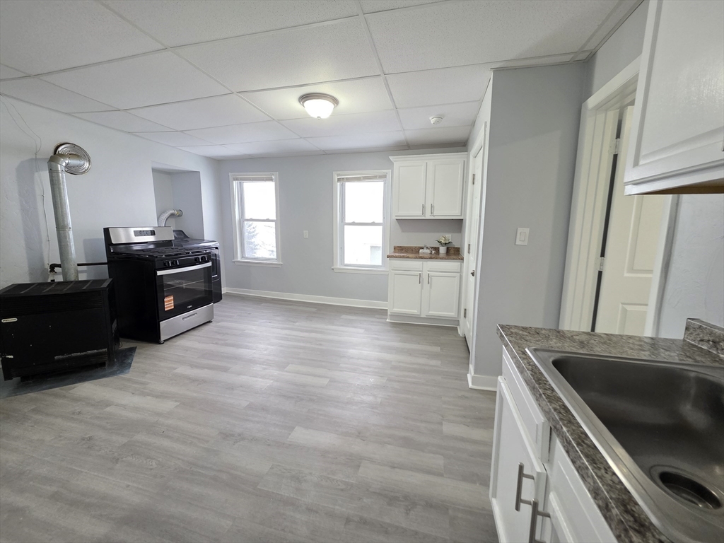 39 Harlem Street, Unit 3 Worcester, MA 01610 - Photo 2 of 18 a kitchen with granite countertop a refrigerator stove and sink