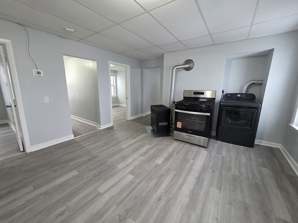 39 Harlem Street, Unit 3 Worcester, MA 01610 - Photo 3 of 18 a living room with furniture and wooden floor