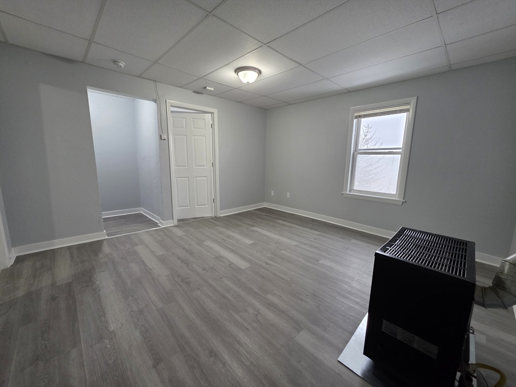 39 Harlem Street, Unit 3 Worcester, MA 01610 - Photo 6 of 18 an empty room with wooden floor and windows