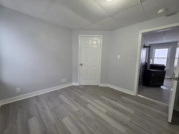 a view of a room with wooden floor