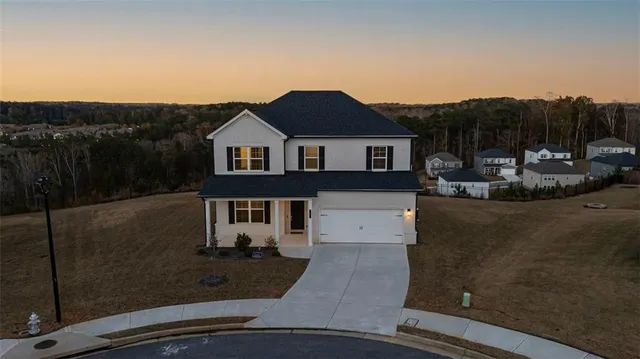 a view of a house with a backyard