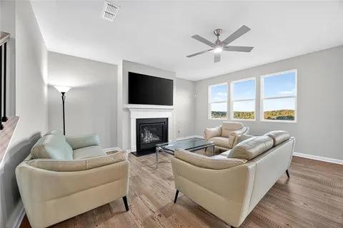 a living room with furniture and a fireplace
