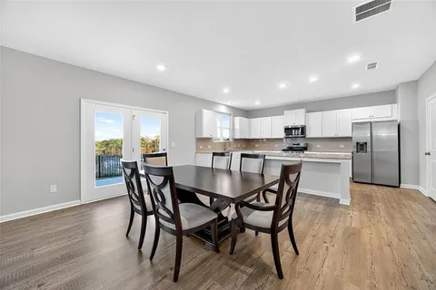 a view of a dining room with furniture and wooden floor