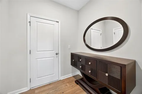 a bathroom with a sink a mirror and a wooden floor