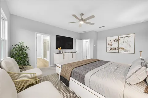 a spacious bedroom with a bed and a flat screen tv