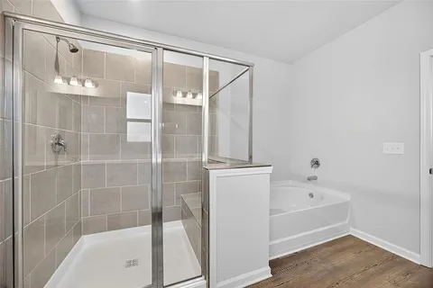 a bathroom with a bathtub and a shower