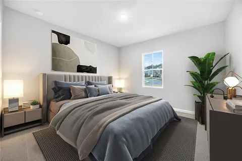 a bedroom with bed and a potted plant