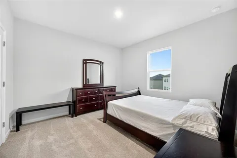 a bedroom with a bed and a dresser