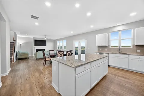 a kitchen with sink stove and cabinets