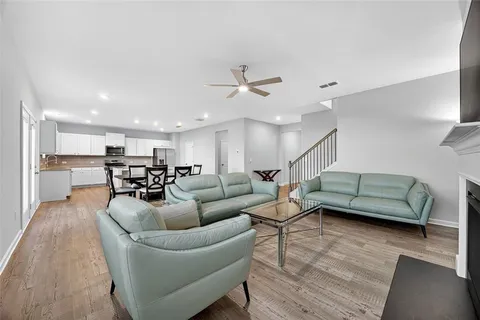 a living room with furniture and kitchen view