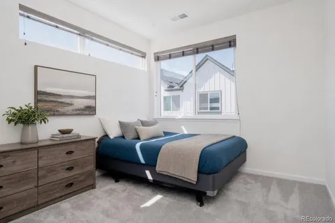 a bedroom with a bed and a dresser in it