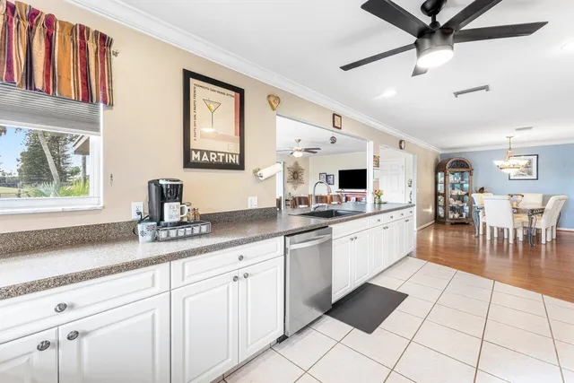 a kitchen with stainless steel appliances kitchen island granite countertop a sink and cabinets