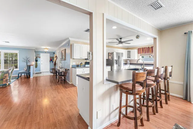 a dining room with furniture and wooden floor