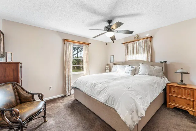 a bedroom with a bed and chair