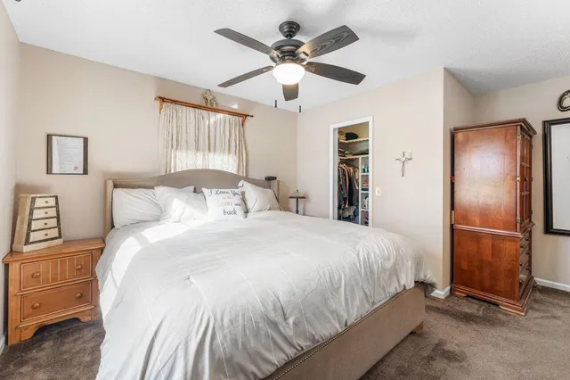 a bedroom with a large bed and a chandelier