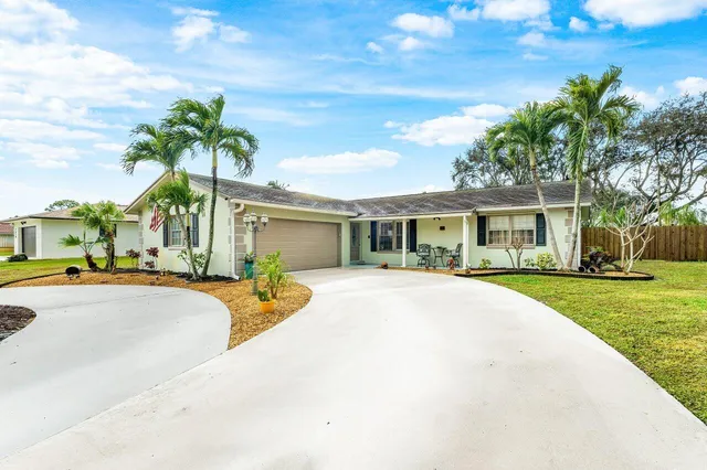 a front view of a house with a garden and patio