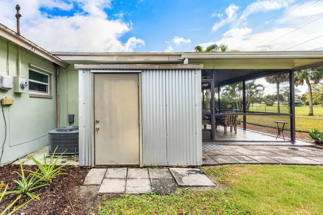 a backyard of a house with table and chairs