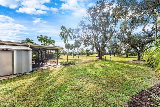 a view of yard with swimming pool and sitting area