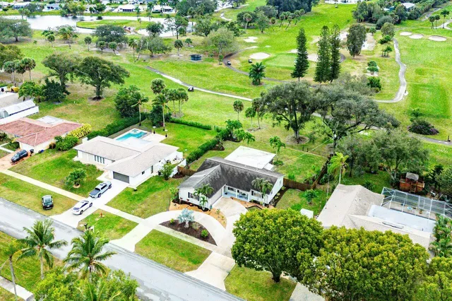 an aerial view of residential houses with outdoor space and street view