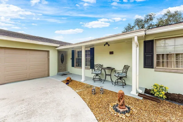 a front view of a house with outdoor seating