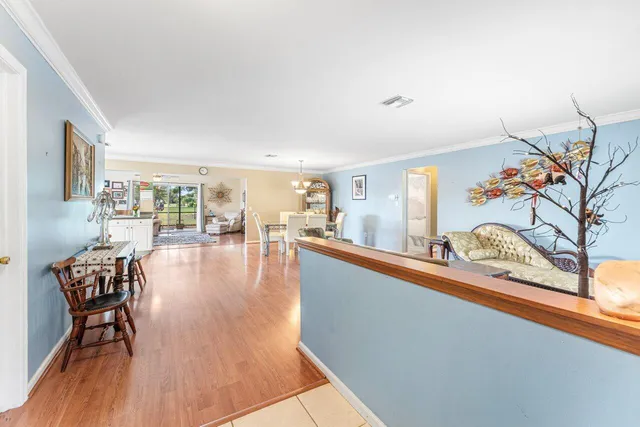 a dining room with furniture and wooden floor