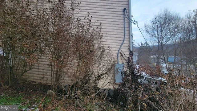 a brick house with a trees in front of it