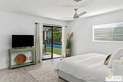 a bedroom with a bed and a television