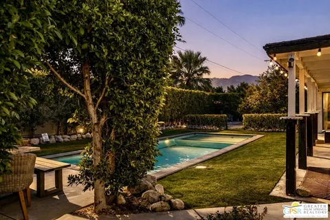 a view of a swimming pool with a chair and tables