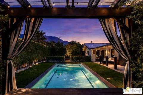 a view of a yard with a chair and a fire pit