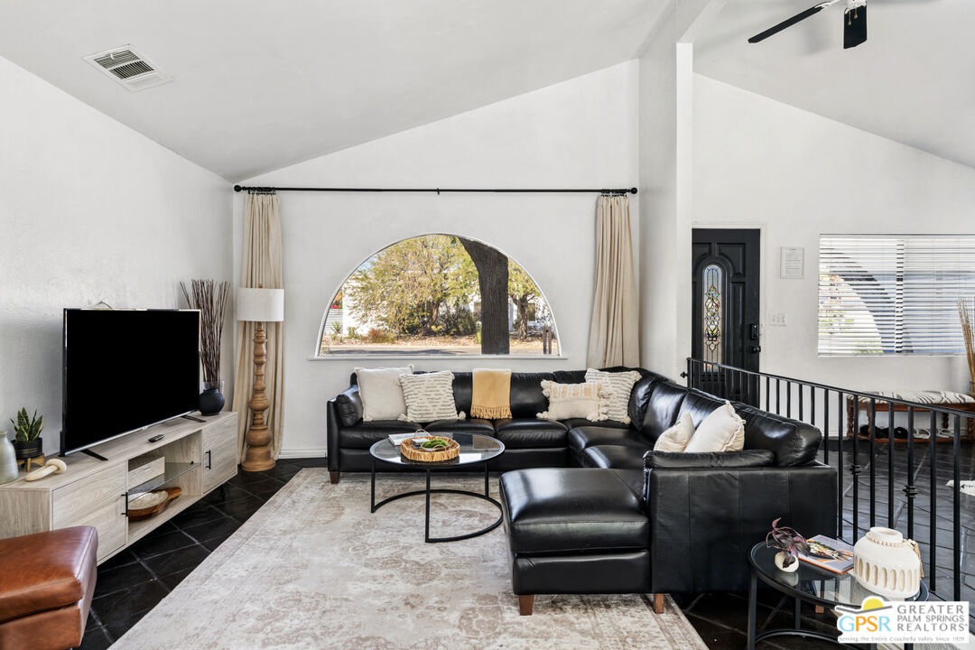 2493 East Powell Road Palm Springs, CA 92262 - Photo 3 of 43 a living room with furniture and a flat screen tv