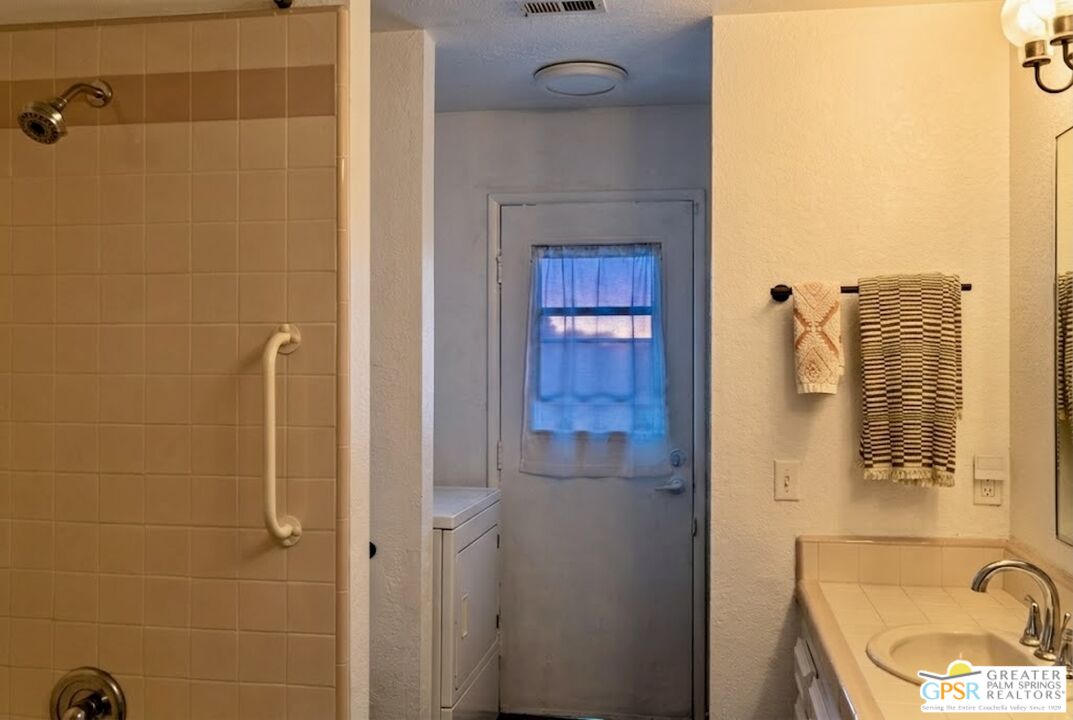 2493 East Powell Road Palm Springs, CA 92262 - Photo 37 of 43 a bathroom with a sink a mirror and shower