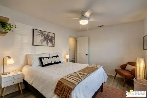 a bedroom with a bed and a chair