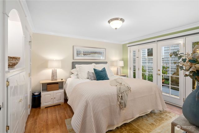 a bedroom with a bed and a potted plant