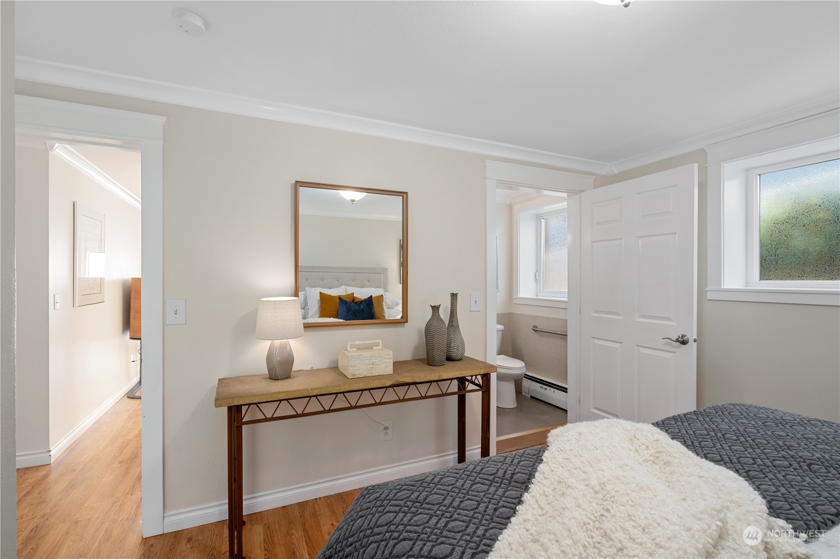 7127 Beach Drive Southwest Seattle, WA 98136 - Photo 22 of 33 a bedroom with a bed and wooden floor