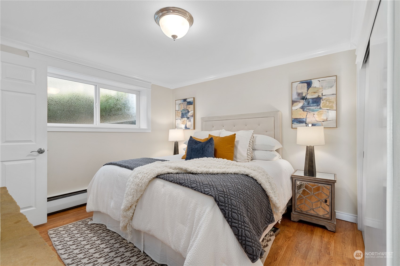 7127 Beach Drive Southwest Seattle, WA 98136 - Photo 23 of 33 a bedroom with a bed and wooden floor
