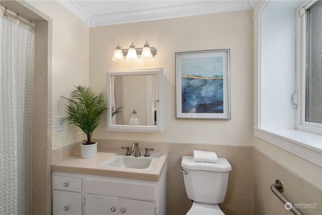a bathroom with a tub a sink and mirror